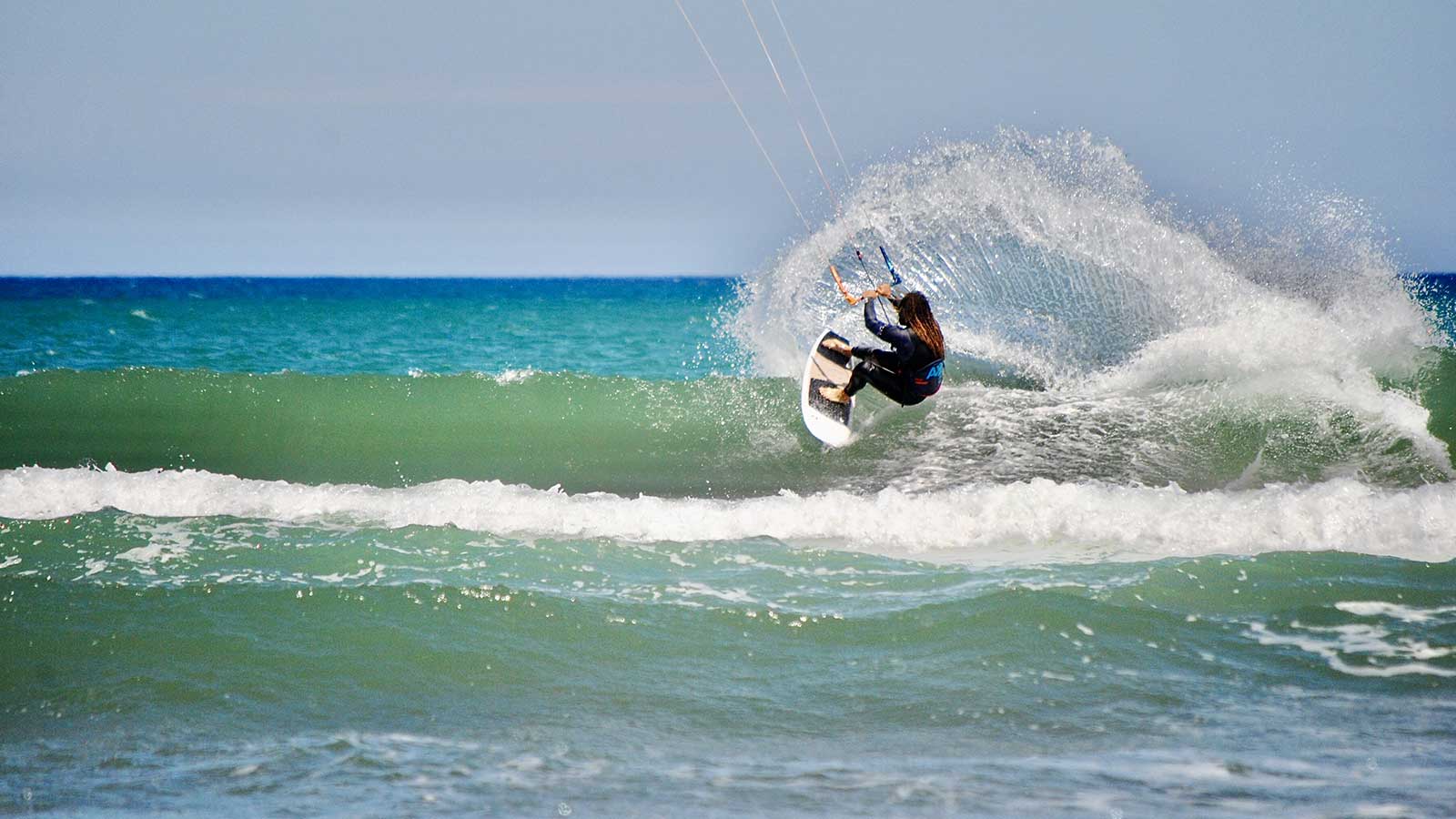 kitesurf sessions in Golf de Roses, Kitesurfer taking a wave