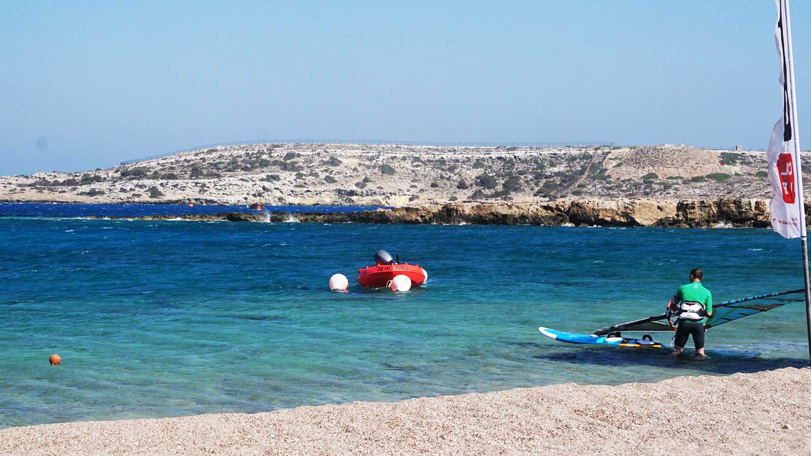 ion club karpathos security boat and a windsurfer going out for a session