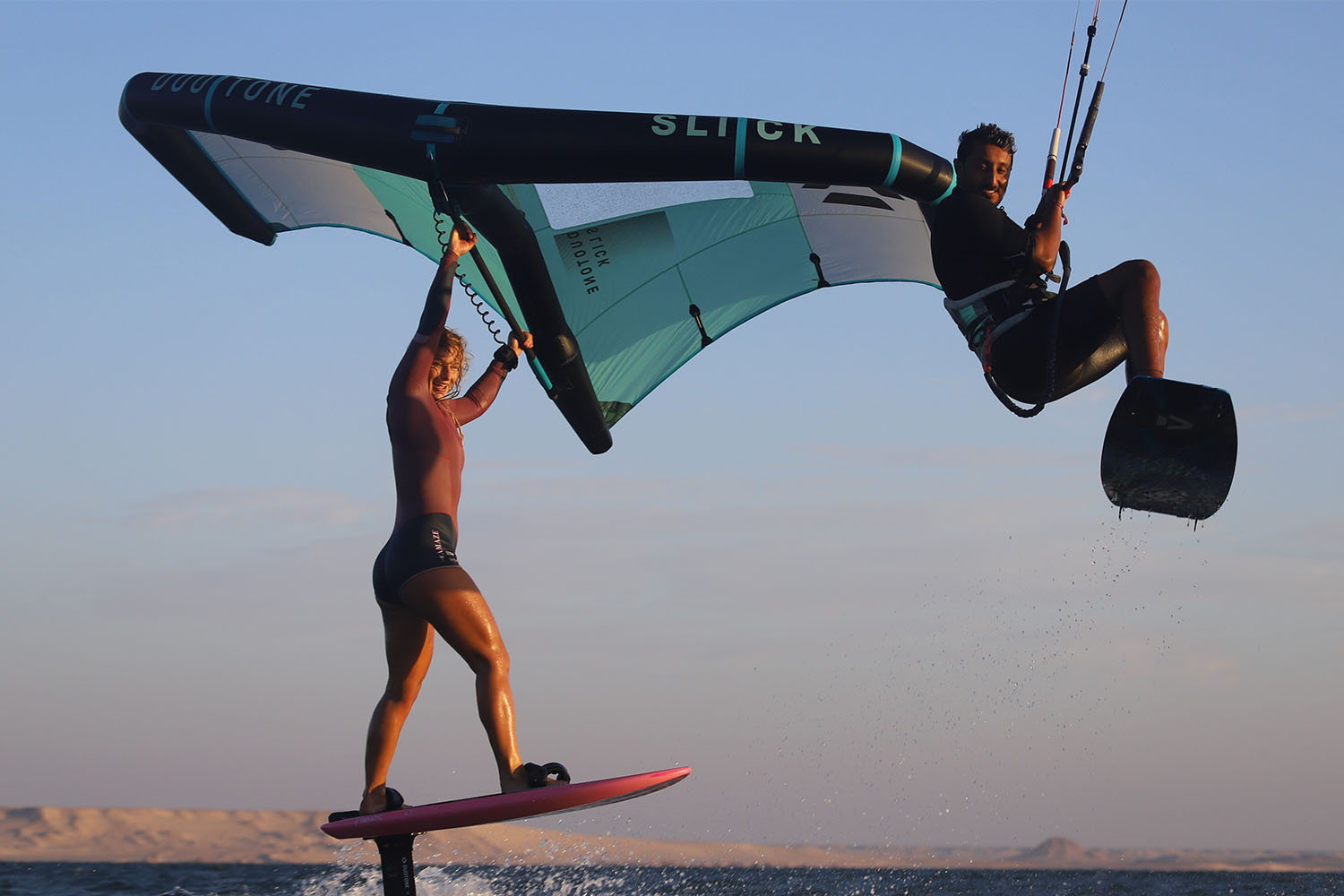 kitesurfer and wingsurfer jumping on the spot in front of ION CLUB Dakhla Lagoon during sunset