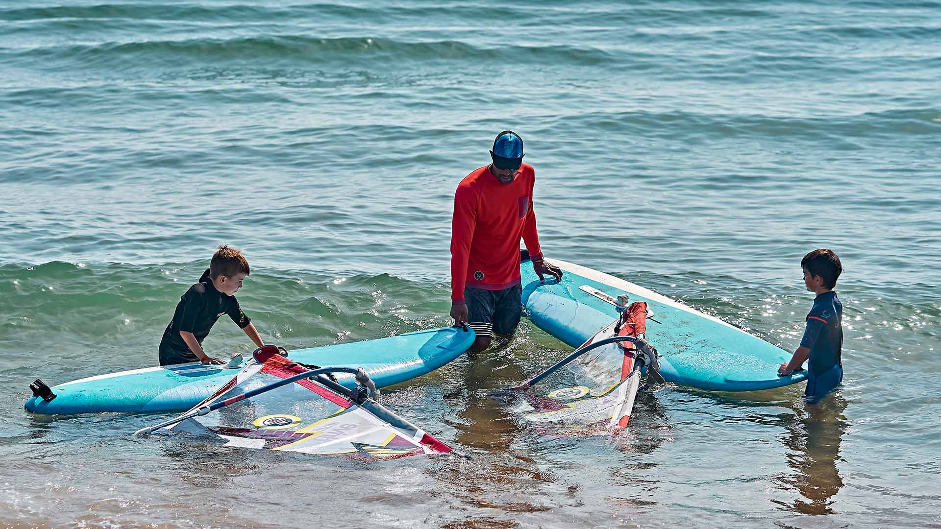 windsurf lessons with two children listening the instructor