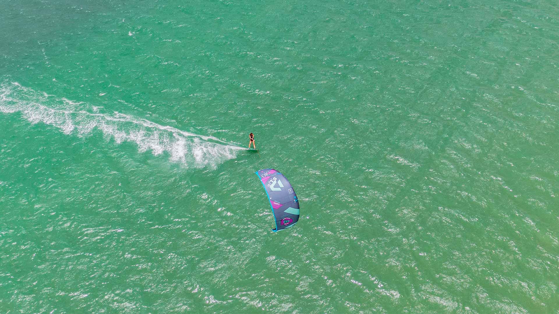 View from the sky of a kitesurfer riding on turquise water of Dakhla Lagoon