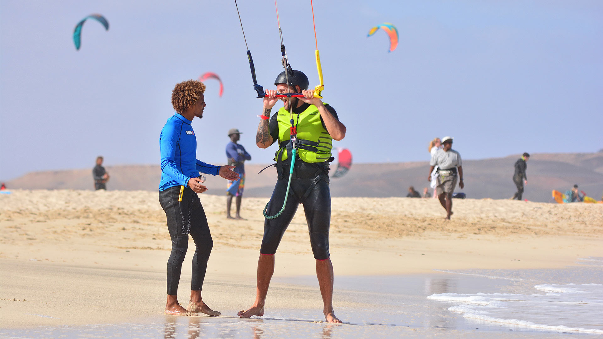 Kitesurfen lessons in kitebeach spot one instructor and his student