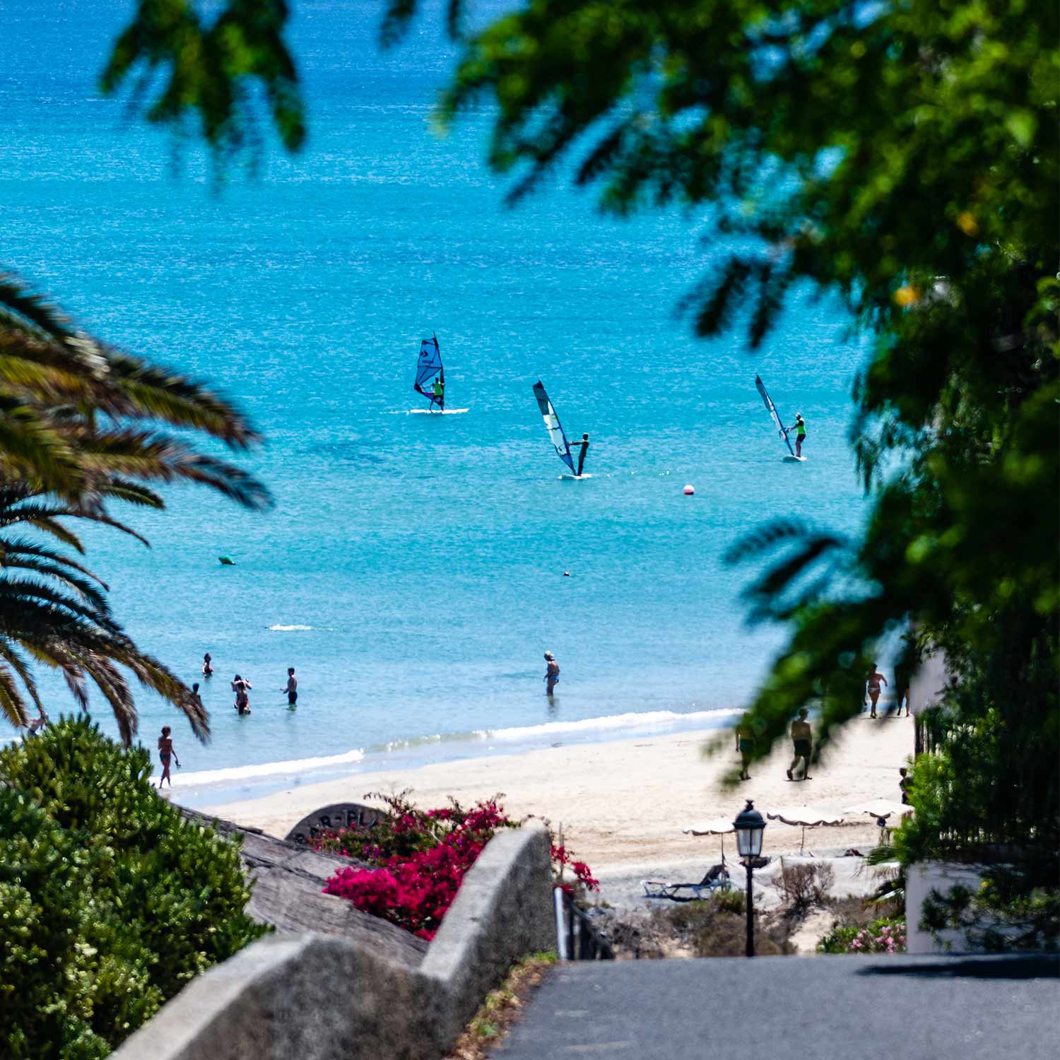 Costa Calma center spot where some windsrufer riding and some people walking on the beach a view compare with Maui