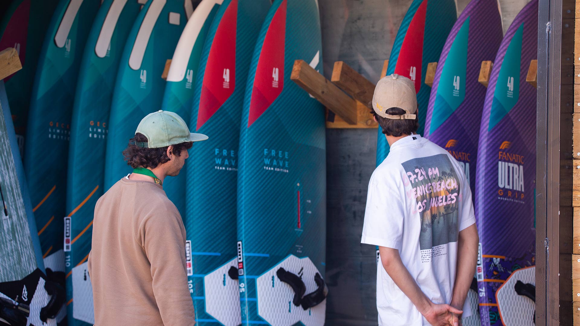 Two guys loking the Windsurf boards to rent in Ion Club Tarifa