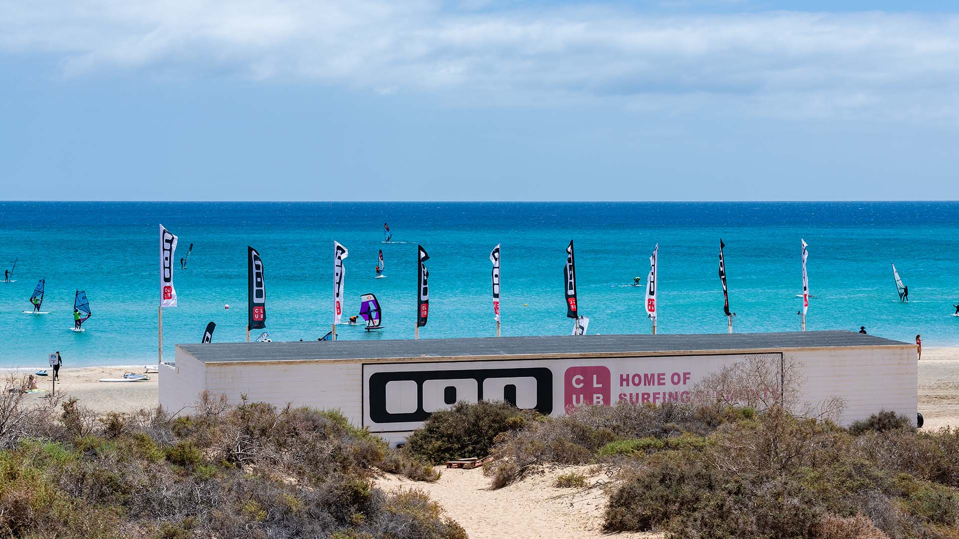 COSTA CALMA_BANNER directional countries pannel on a beach with ion club