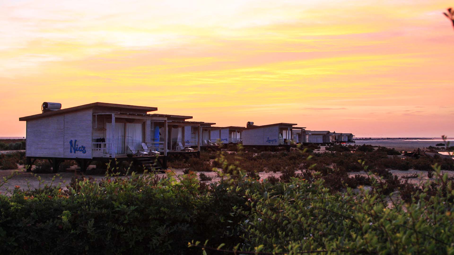 sunset in morocco next to the beach with bungalows
