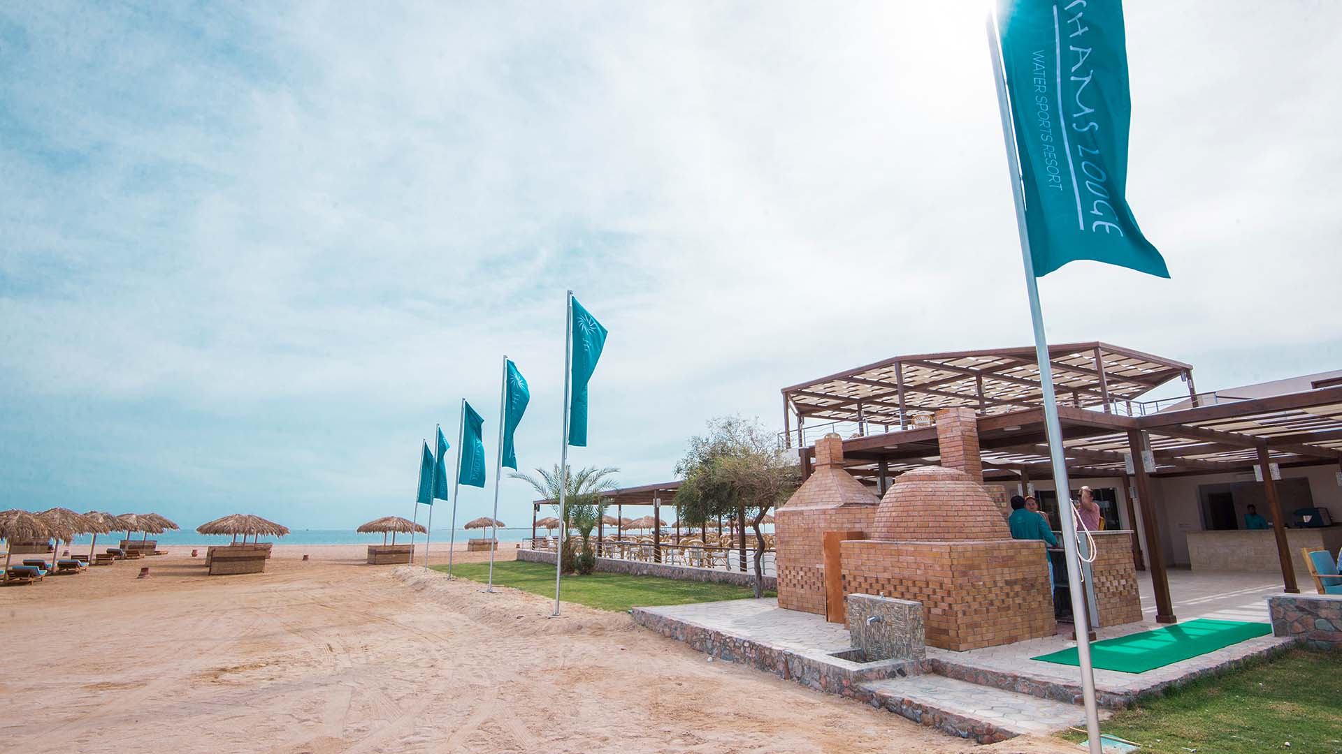 shams lodge on the beach in safaga with flags