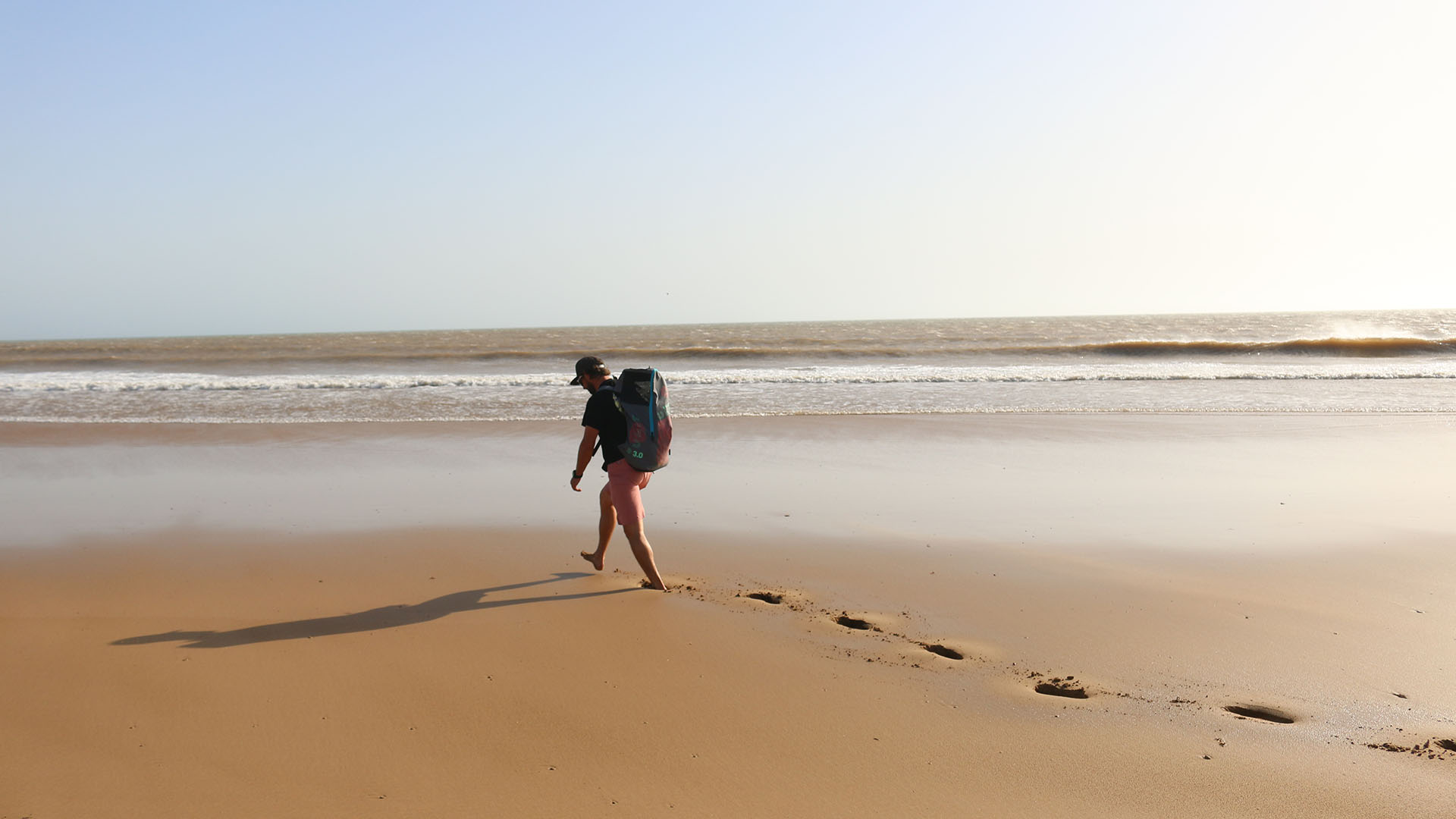 excursions beach with foot prints on the sand