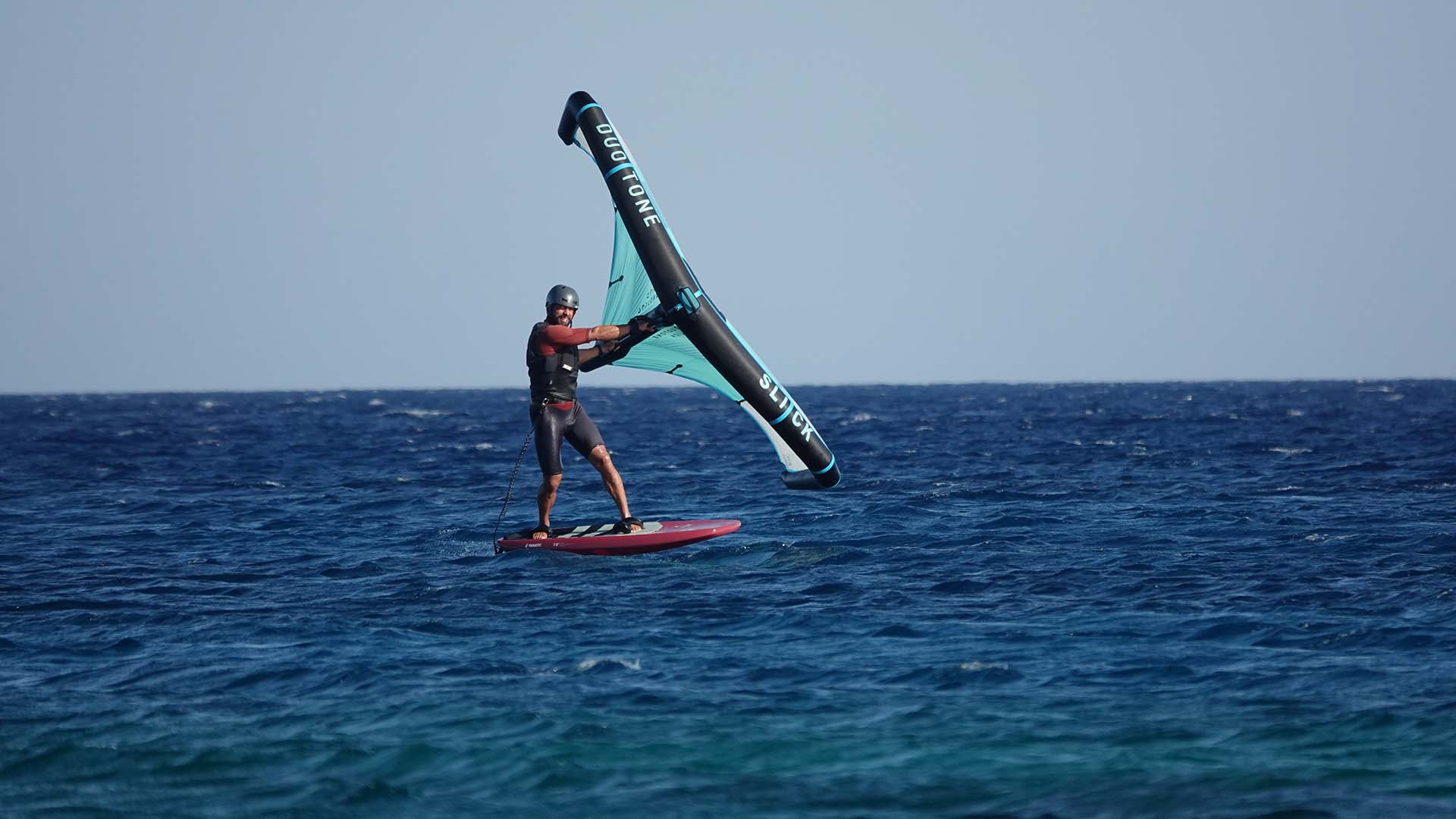 On the horizon many kitesurfers are sailing the waters of the Red Sea and in the foreground is one of the instructors of the Ion Club Safaga. 