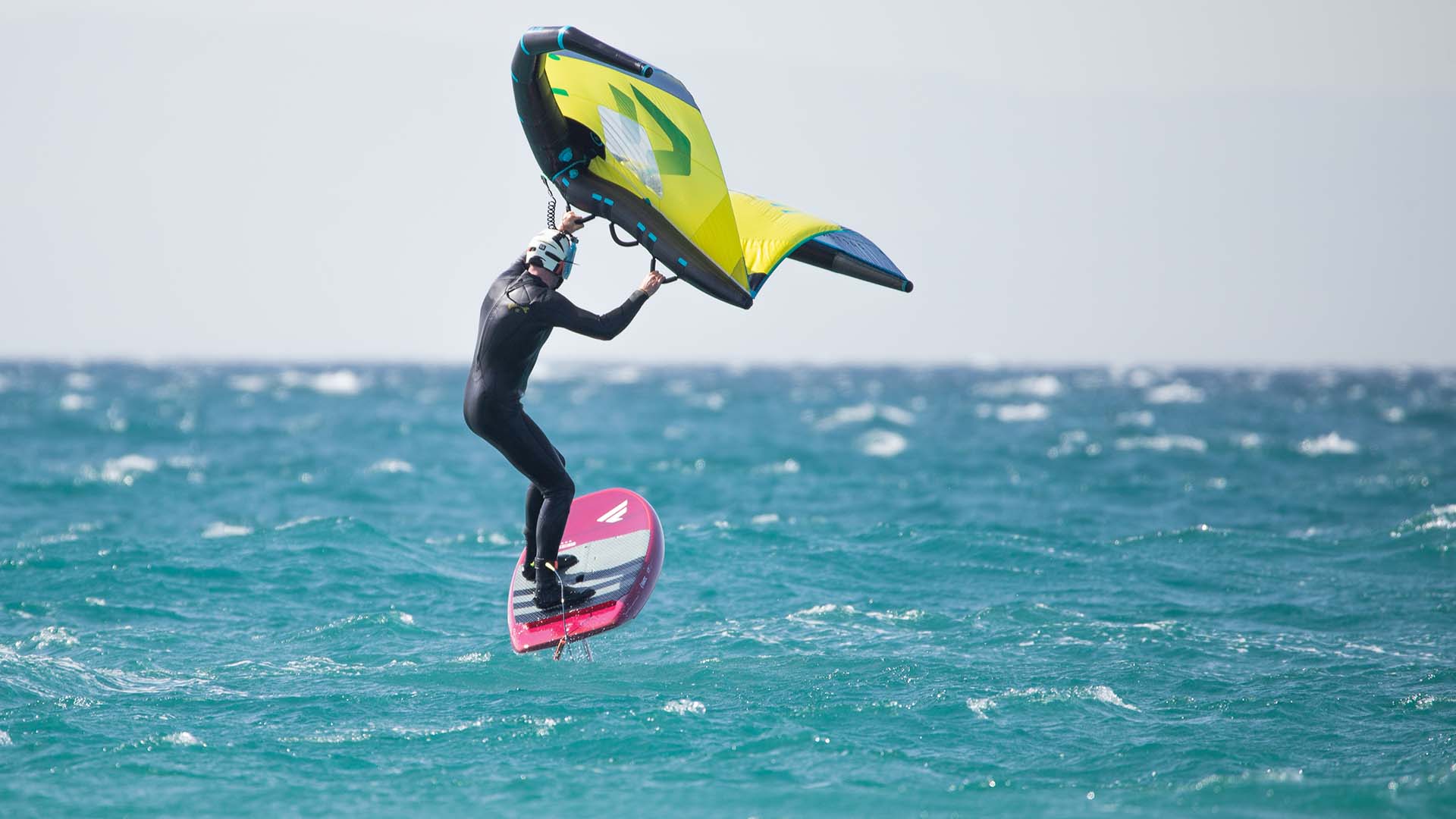 Woman student is learning how to stand up on the surf board