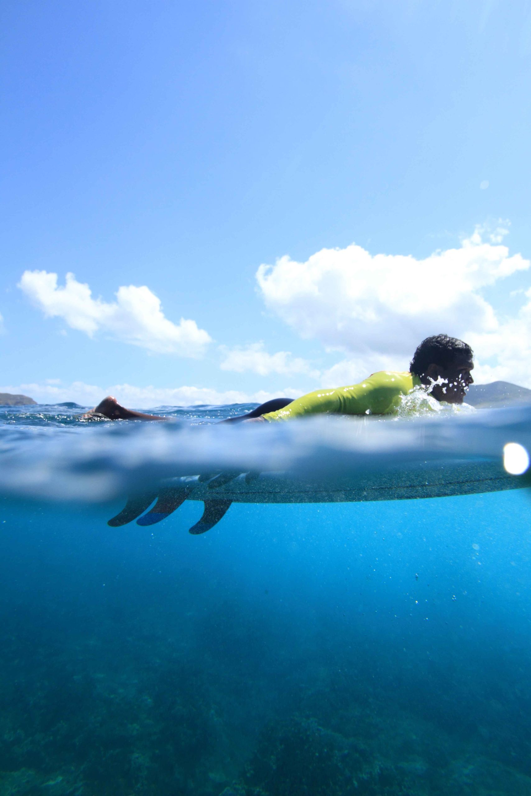 Woman student is learning how to stand up on the surf board