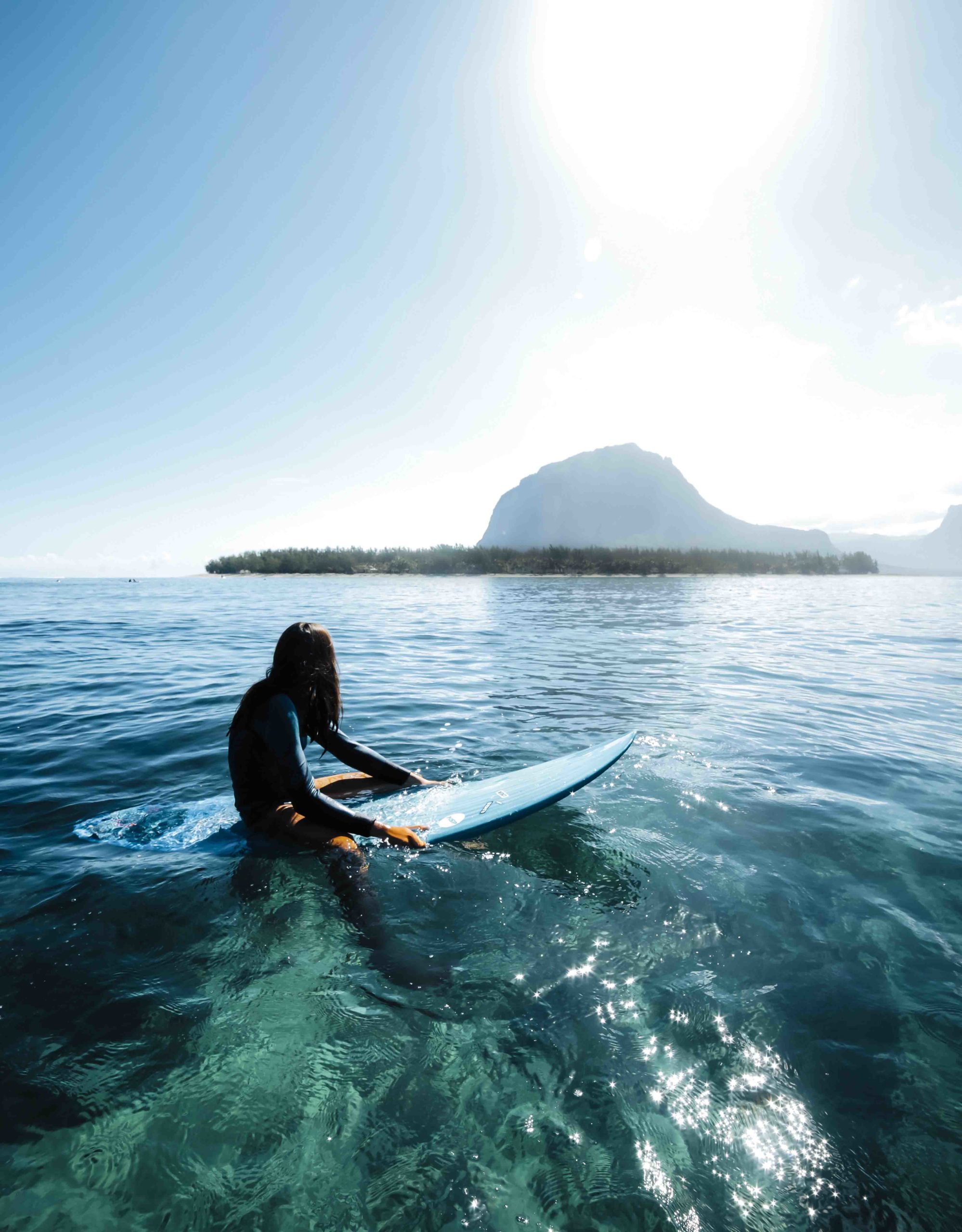 A young man has fun surfing a wave sitting on his surfboard at the on Club Lassarga spot.