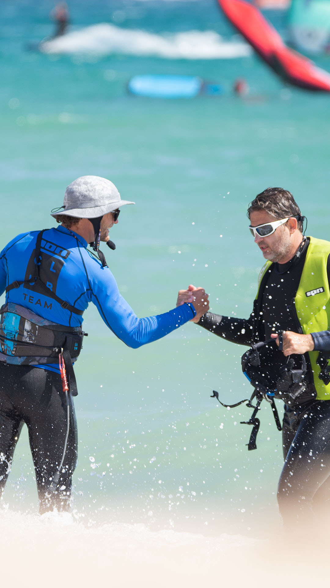 kitesurf instructor with a client checking hands 