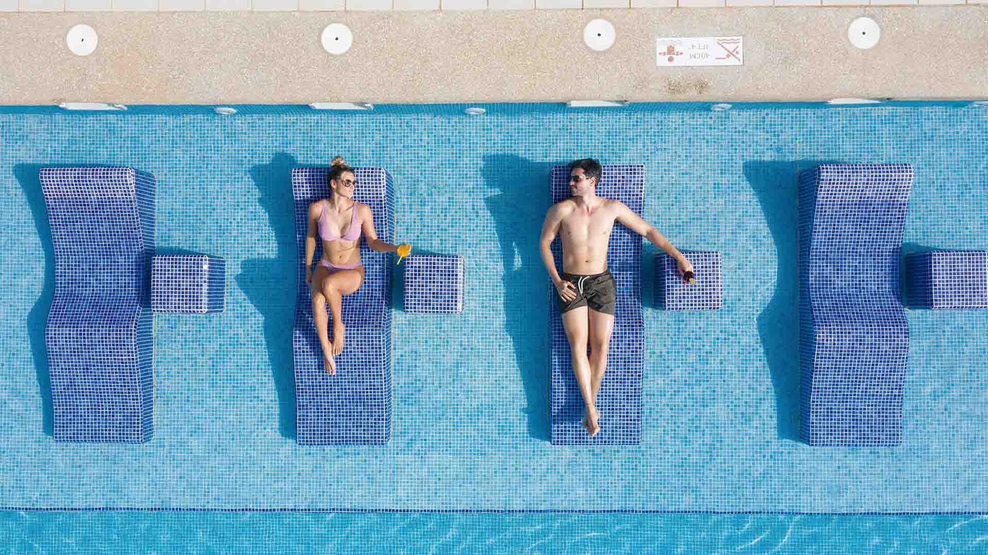 two people in the swimming pool blue
