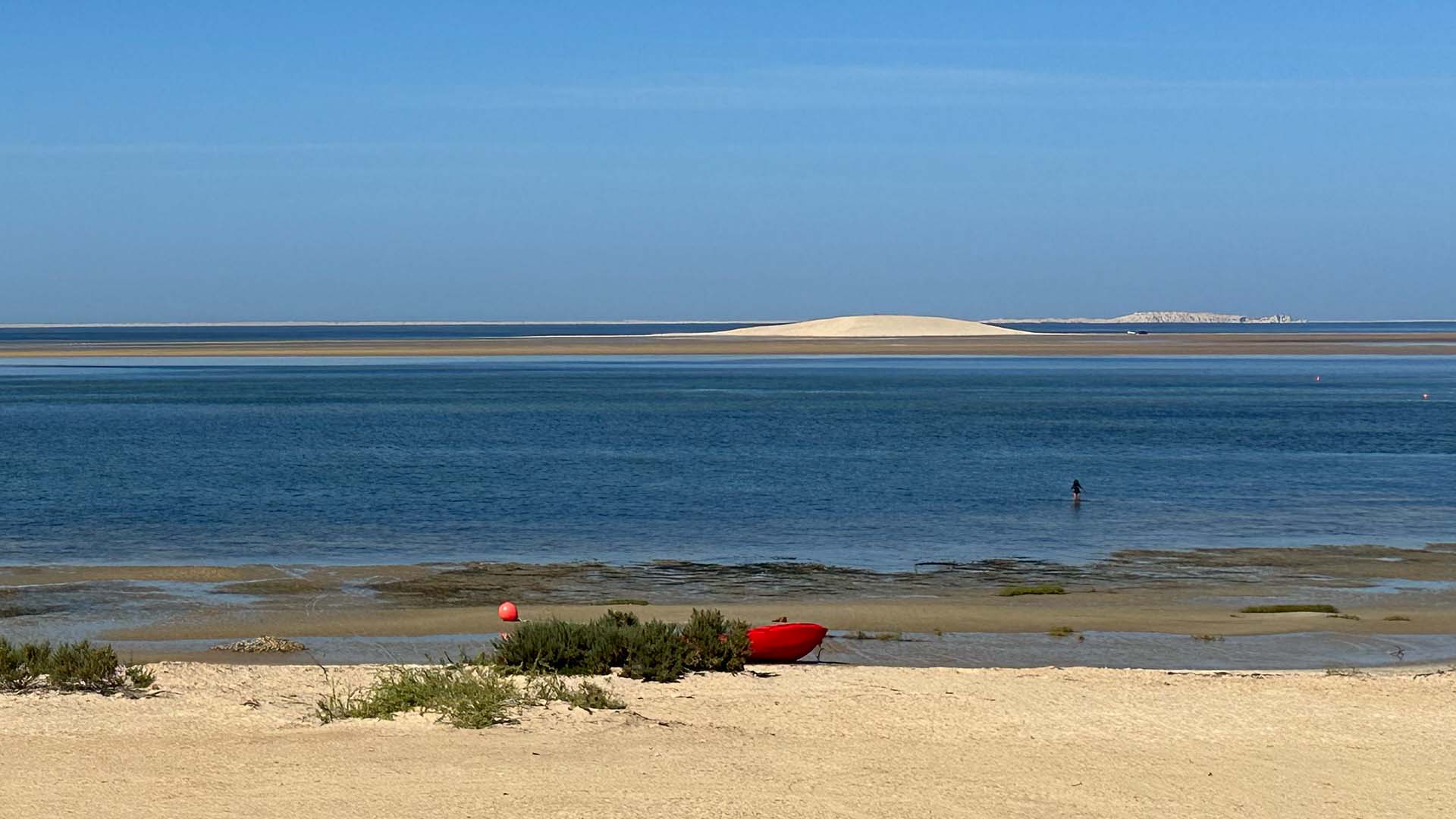 dakhla white dune with a red boat