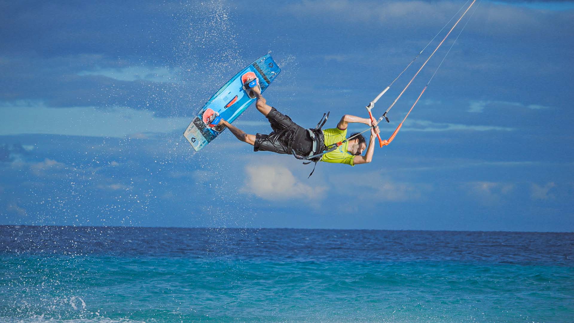 man with an ion wetsuit and a kite on the beach