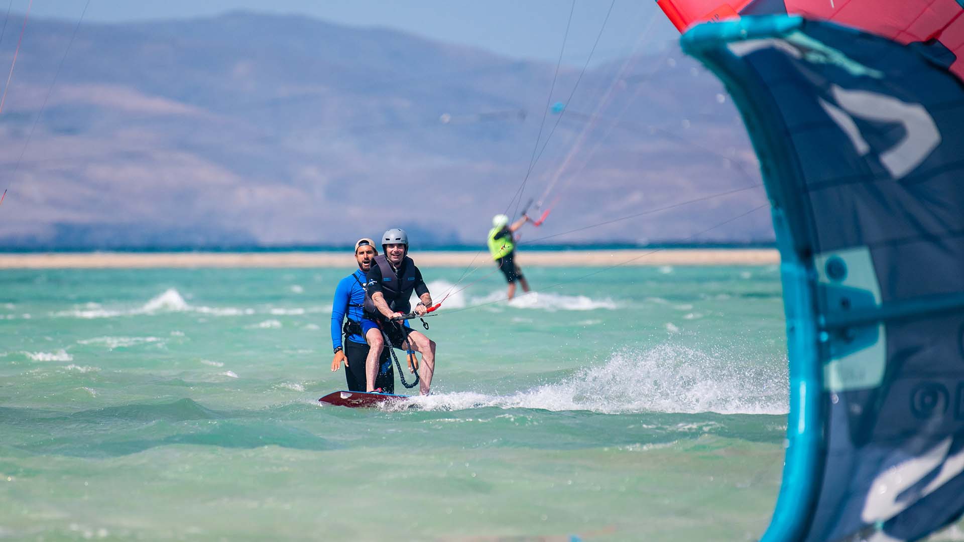 girl with an ion wetsuit on the beach with wind